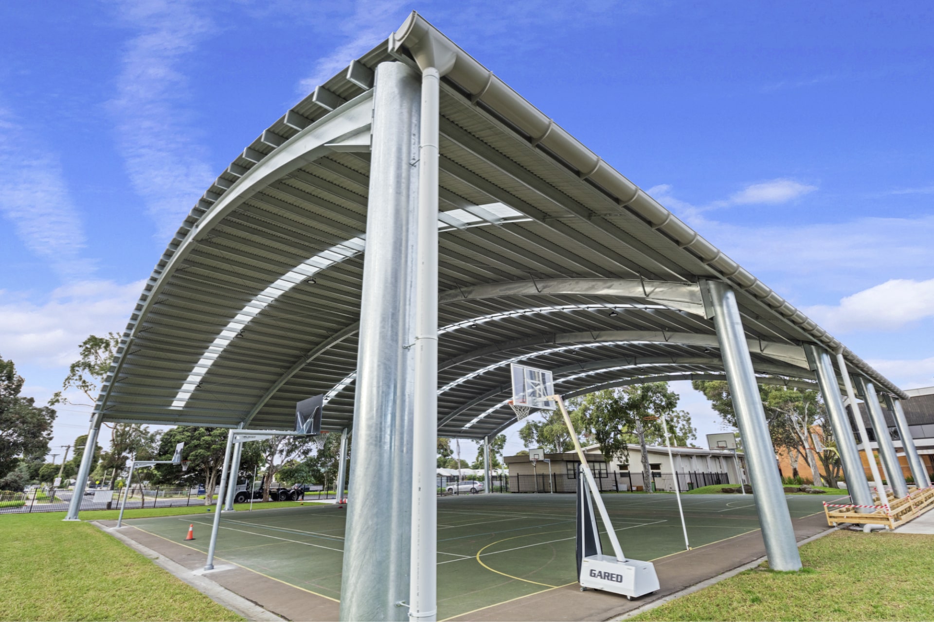 Curved steel school shade cover structure